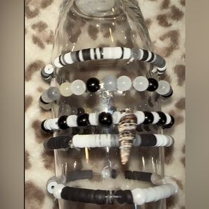 Five piece, black, and white bracelets